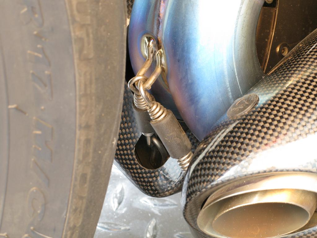 www.akrapovic.com 11. Unscrew the marked bolts and partially remove the right rider s foot rest (Figure 37).