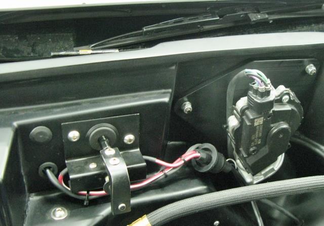 Route the wiper door motor wire terminals into the cowl area through the firewall using an exisiting hole next to the