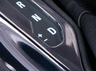Move the shift lever to the left of the Drive (D) position. Tap the shift lever forward (+) to upshift or rearward to downshift ( ).
