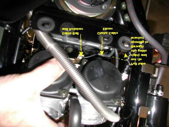 Lean the carbs forward and find the choke cable. Pull the metal elbow of the choke cable to the right and slide the cable out of the slot in the mount.
