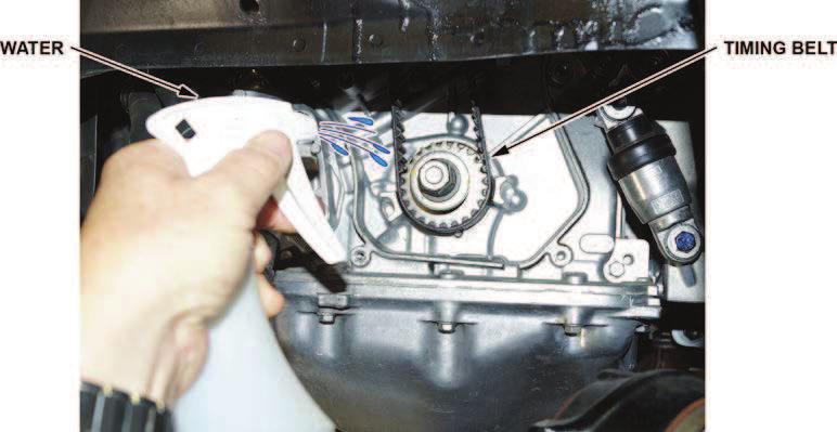 12. Start the engine while it is still hot, then spray the back edge of the timing belt with water while it is running.