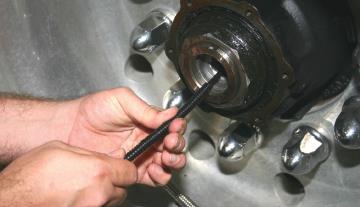 If a screw was used to help feed the tubing through the axle, cut above the screw and discard.
