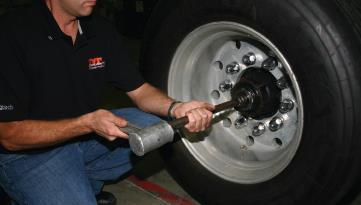 spindle into the axle bore until the flange of the spindle plug is flush against the