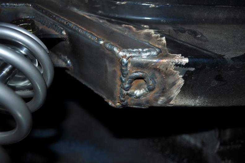 16. Attach the lower coil over mount into the holes on the lower trailing arm brackets on the differential tubes. The lower you locate the bracket, the lower the car will sit.