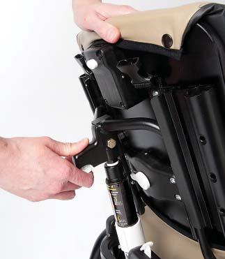 While still holding the backrest down, turn the white twist-lock collar to the right until it locks. This function is easier to perform with your client in the chair.