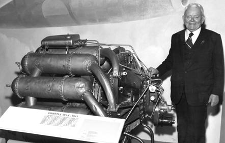 Frank Whittle stands next to the engine he designed, designated Whittle W1X, on display in the jet gallery at the National Air and Space Museum in Washington, D.C.