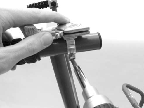 Insert barrel into the slot so when the throttle cable is pulled, it will pull the throttle