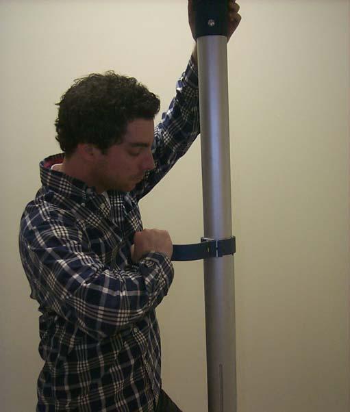 Placing one hand on the Top Post Section and one hand on the clamp, swing the Post Clamp around
