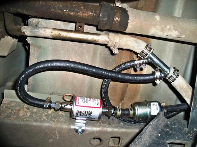 (Fig. 15) Vent Fill Neck Adapter installed. (Fig. 16) Fuel Door located in outside fender. 18 Connect 3/8 line from pump to largest tubing on Vent Fill Neck Adapter.