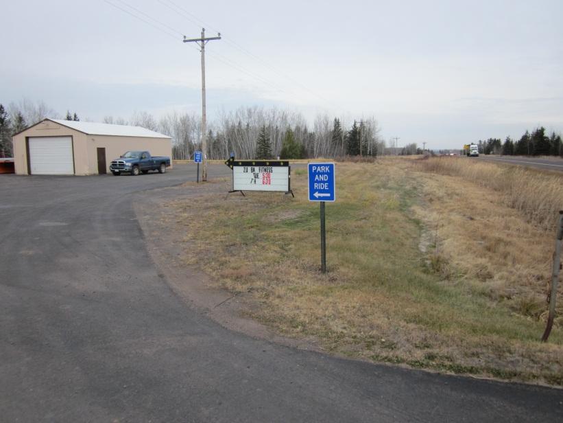 the lot, near the small metal pole building, in the parking