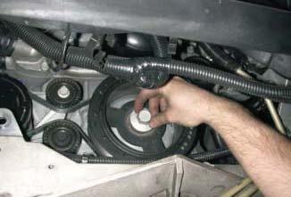 Using a 24mm socket tighten the new harmonic balancer bolt according to General Motors specifi cations.