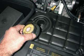 With a cool engine remove the radiator cap and drain the coolant into a clean drain pan for reuse later.