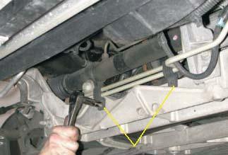 Using a 18mm line wrench, disconnect the power steering high and low