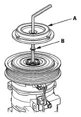 Fig 10: Identifying Pressure Plate And Shim 3. If you are replacing the field coil, remove the snap ring (A) with snap ring pliers, then remove the pulley (B).