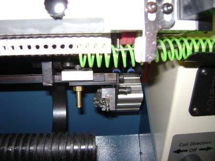 Step on the foot switch or press the start cycle button. The front comb will clamp the book, the coilbed will drop away and the spinner wheel will drop down onto the coil.