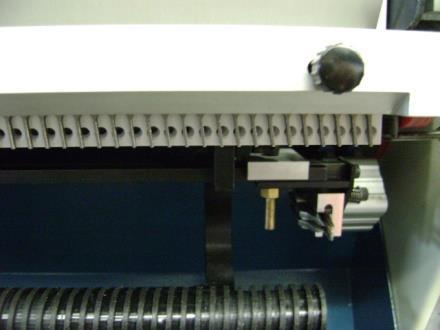 Turn the side guide adjustment knob, Figure 18 to move the side guide, Figure 25 D left or right while gently pushing the cover against the side guide.