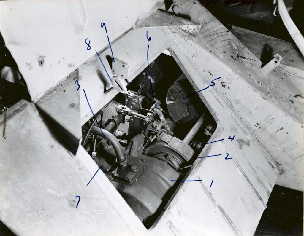 8 US Military Intelligence Report Remote-Controlled Demolition Vehicle, B IV c Photo 2: View of power train through opening in front plate. 1. Controlled differential. 6. Brake pedal. 2. Left steering brake.