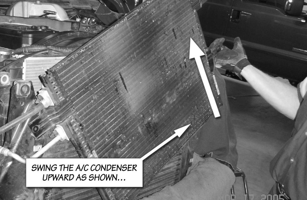 Caution: Minimize the amount of stress to the A/C condenser fluid lines to prevent damage.