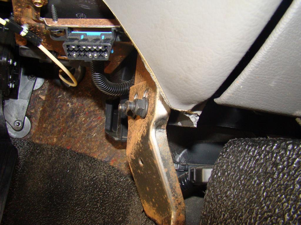 17) On the driver's side center, remove these two nuts and pull the bracket off the studs.