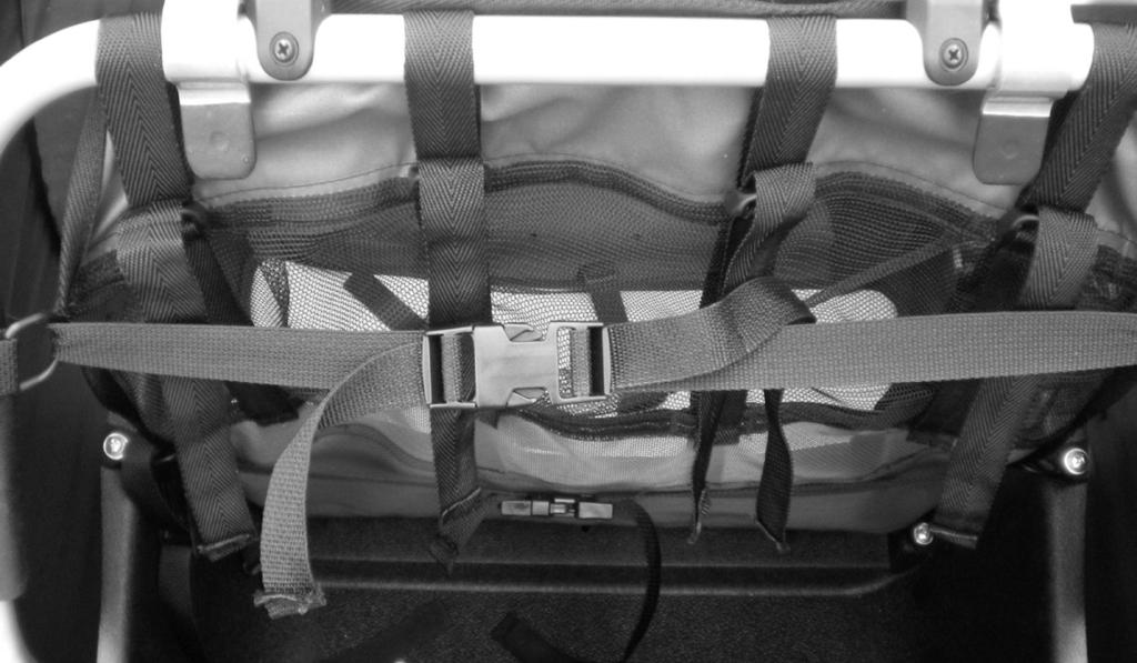 Attaching the Seat 1. Behind seat, fasten buckle sections together on upper and lower straps and adjust as needed. Photo 1 2. Before closing trailer, unfasten buckles behind seat.