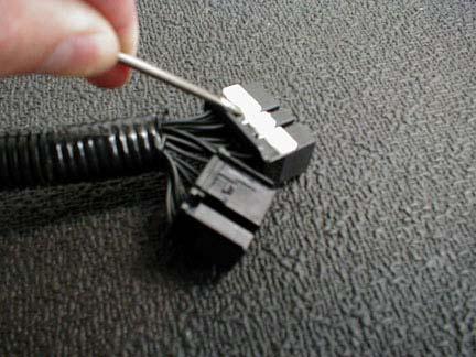 20. Pry up the white pin-locking bar on the 31-way connector of the TRD ECU Harness (Figure 33). Lift Figure 33 21.