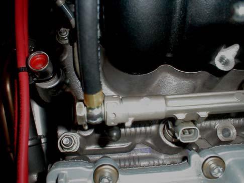 13. Tighten all of the fittings TRD double banjo bolt and both ends of the fuel line. NOTE: Make sure the factory banjo tab is oriented against the fuel rail tab (Refer to Figure 10). 14.