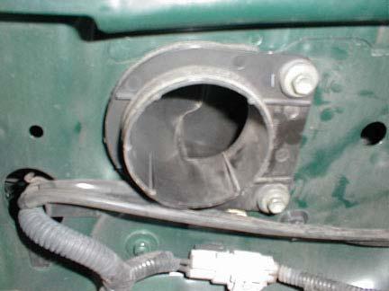 From the engine bay, remove the 2 bolts that hold the intake elbow to the fender (Figure