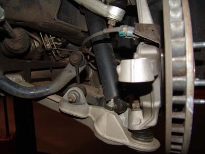Figures 2a and 2b (Removal of tie rod end): Once the tie rod ends are removed from both sides we must now separate the upright from the lower control arm to