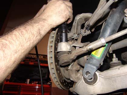 Start by removing the wheel and tire, then move onto removing the lower shock bolt and nut from both sides.