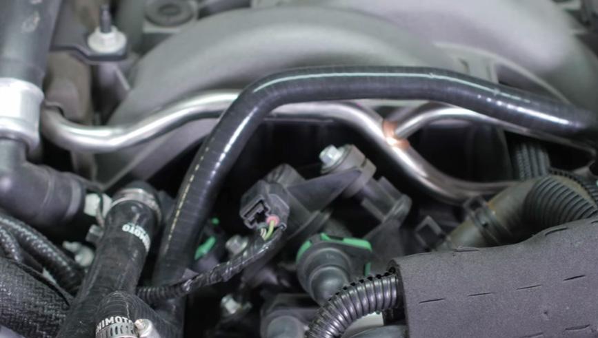 Locate the Mishimoto coolant bypass hose in your ancillary hose kit.
