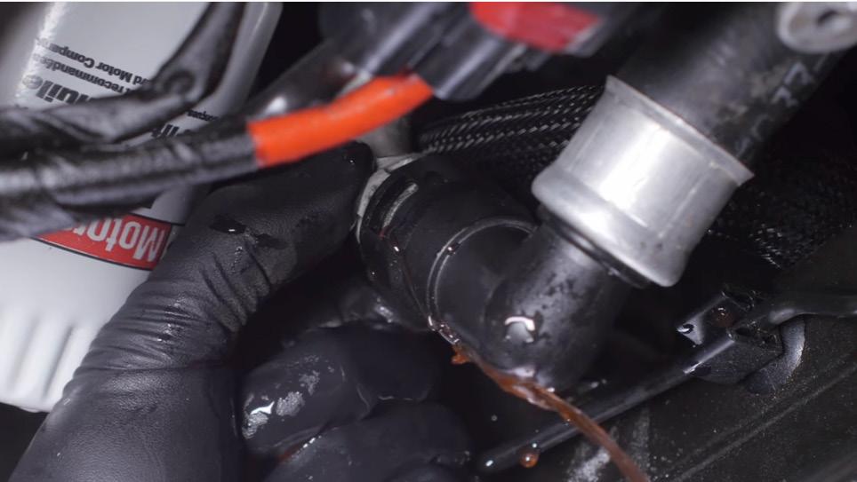 This ridge must engage the bead roll on the oil cooler pipes to form a proper seal. Install a hose clamp over each oil cooler hose and attach them as shown here.