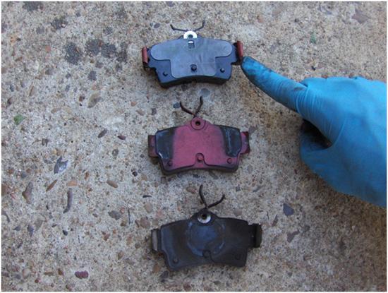 8. Now remove the two clips on the sides of the old worn pads and install them onto the new brake pads. Then apply the brake grease onto the pads. NEVER PUT GREASE ON THE BRAKING SURFACE.