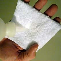 The second person follows the first person - wiping first with a paper towel in the left hand and then wiping again with a 100% cotton towel in the right hand.