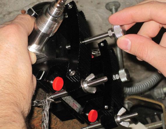 Replace transducer under set screw and tighten firmly with the large bolts located in the center of the clamping fixture. Hand tighten only! See Figure 5E.