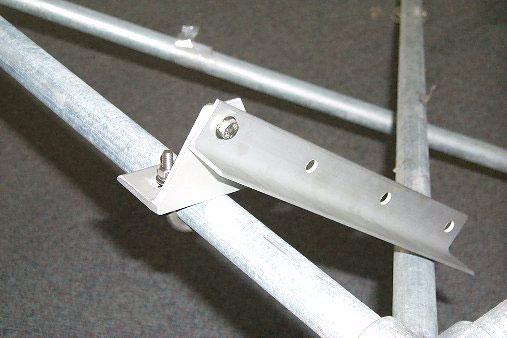 2. Attach the primary support legs to the rear brackets, as per the instruction sheet included with the solar panel. The leg should go on the outside of the bracket, as shown in Figure 5.