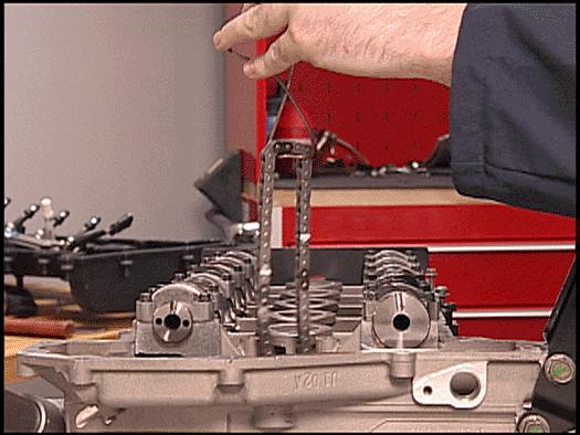 while still engaged with the timing chain. Refer to the above illustration.