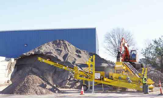 Stationary Hook lift truck or optional roll-off truck mobile Power Unit Electrically powered by RUBBLE MASTER crusher.