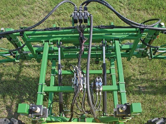 slopes and uneven field conditions. This top view of the boom suspension system depicts lift cylinders and accumulators.
