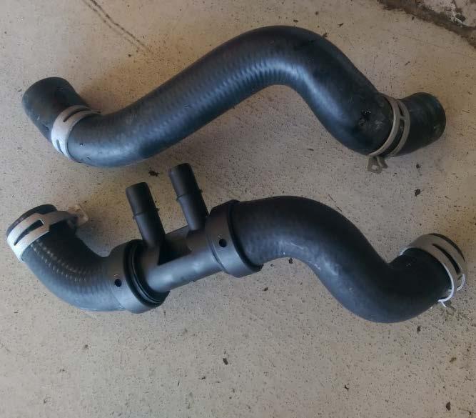 To pull the bottom hose off you need to do the same thing, squeeze the clamp, and slide it off of the radiator.