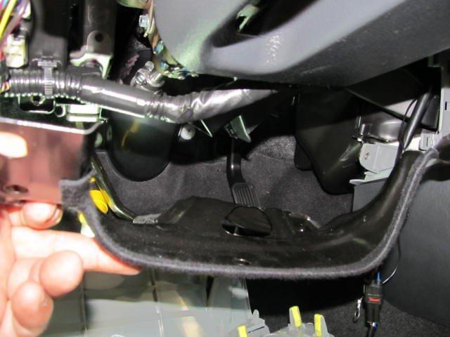 Optional: Remove the metal lower knee panel by removing three 10 mm bolts (picture 11) Picture