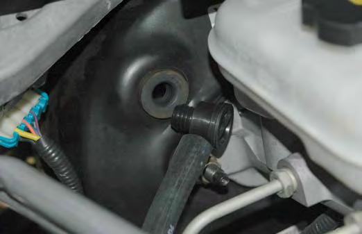 On the driver (left) side of the engine connect the brake hose