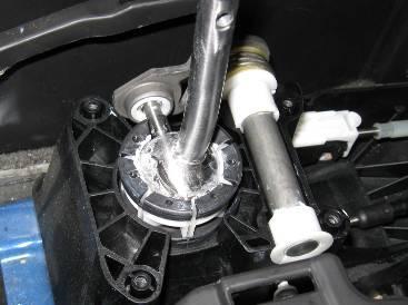Page 10 Pictured to the left: The short shifter installed with the side pivot cup in the steel side arm, and the steel cross pin with white plastic bushings properly seated in the