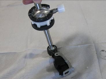 This is easily performed by placing the cable housing on a firm flat surface and pushing the shifter pivot ball in to it as shown to the left. 22.