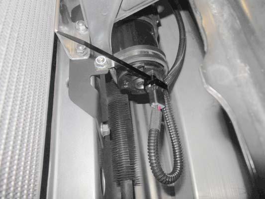 Use a cable tie to secure the wiring harness to the pump at the location shown. Trim the excess cable tie. 227.