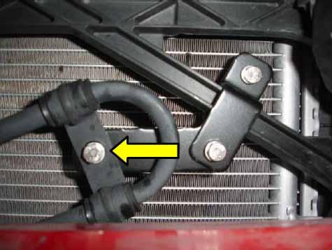Using the Cobb power steering cooler brace, attach the brace to the chassis on the passenger side bumper