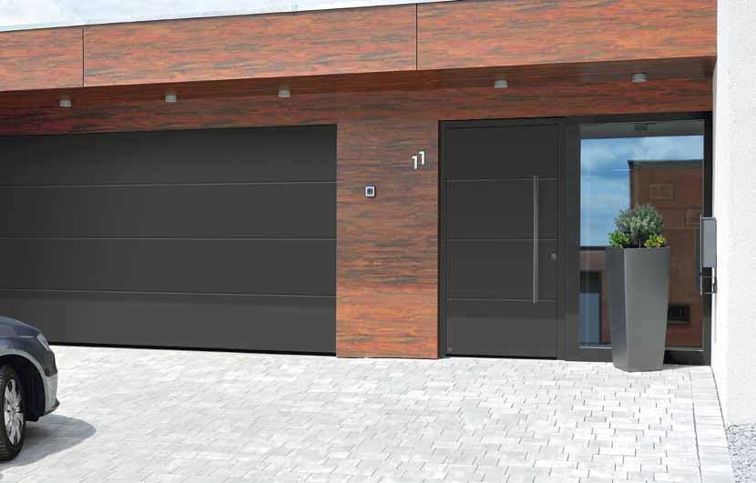 ThermoSafe style 895 in the preferred colour Anthracite RAL 7016, matt, L-ribbed sectional garage door in Silkgrain, Anthracite RAL 7016 Matched entrance and