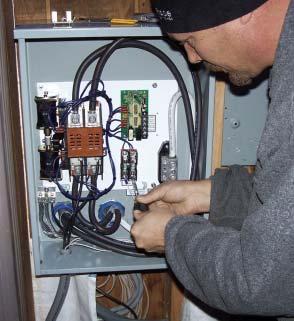 Standby Generators Figure 3. At left, the electrician attaches a white control wire to a fuse block connected to the electronic controller above.