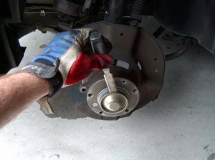 This is called staking, and it prevents the nut from walking off the axle threads during use.
