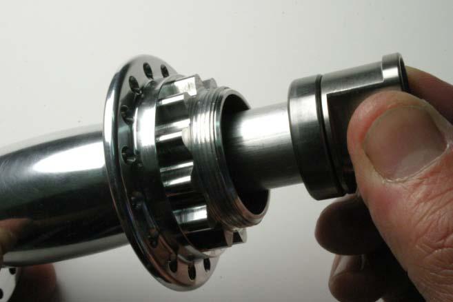 2. Install new bearing into the freewheel side of the hub shell using a bearing press. Be careful that the washers remain in place while bearing is pressed fully into bore. 3.