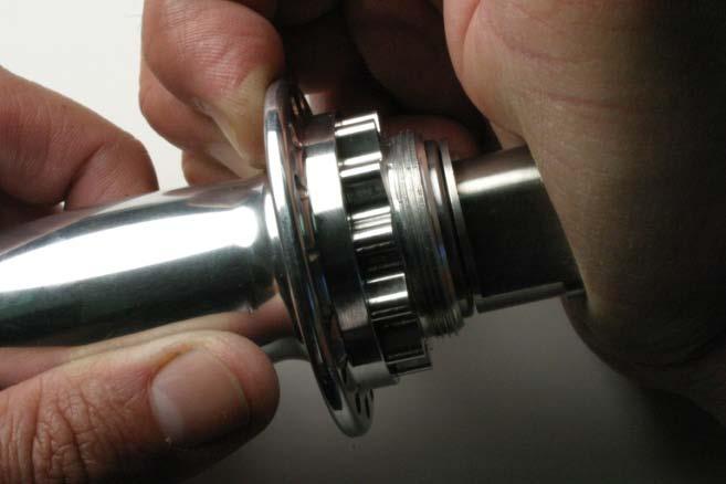 You can use the 19mm wrench to hold the flats of the axle end while you tighten the 4mm bolt. Fig.18 Installing new bearing. Fig.19 Installing 4mm bolt. 4. Insert axle/bearing assembly into hub shell on the fixed gear side (Fig.